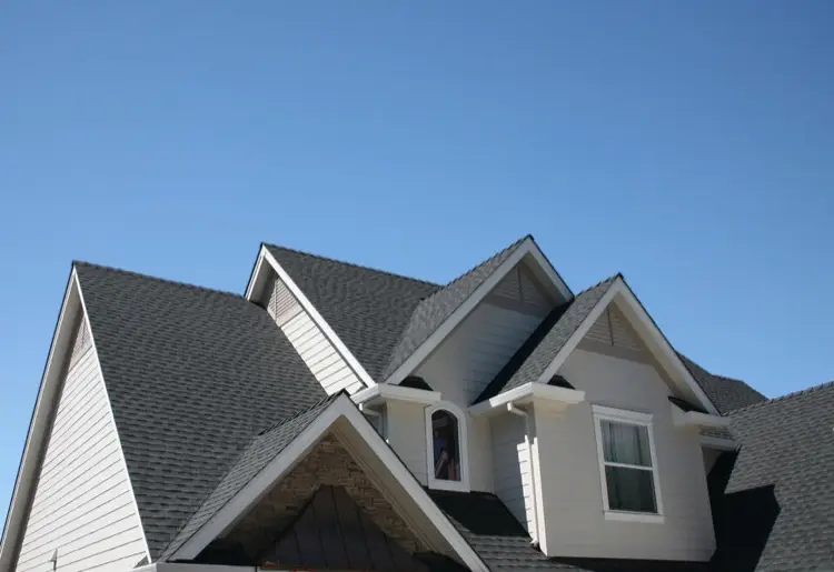 Steep pitched roof with new dark gray roof shingles
