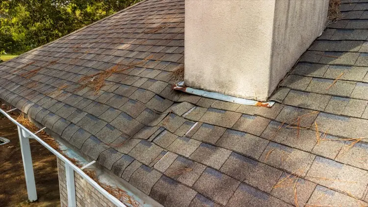 Sagging shingle roof showing structural damage